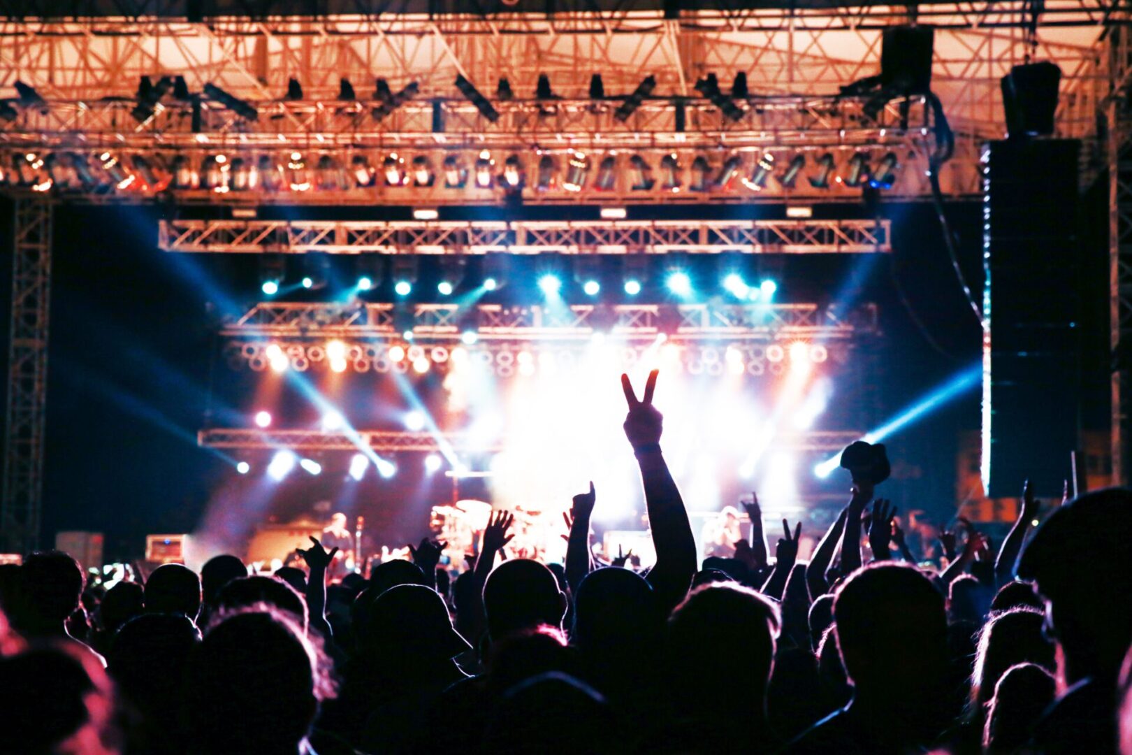 A crowd of people at an event with lights.