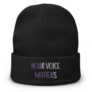 A black beanie hat with the words " your voice matters ".