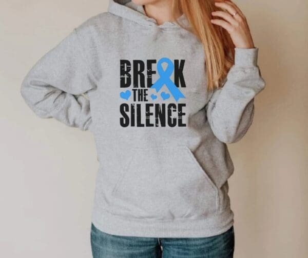 A woman wearing a hoodie with the words " break the silence ".