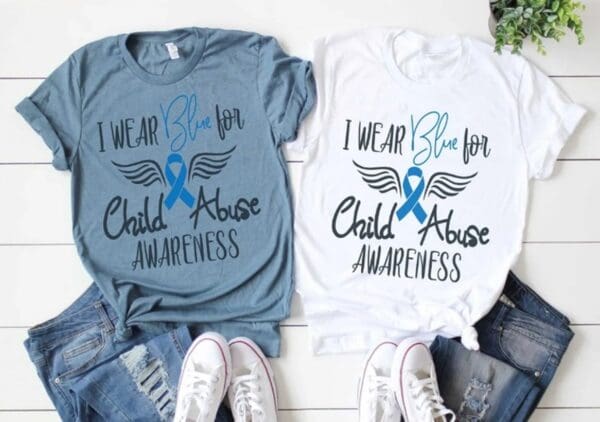 Two shirts that say i wear blue for child abuse awareness.