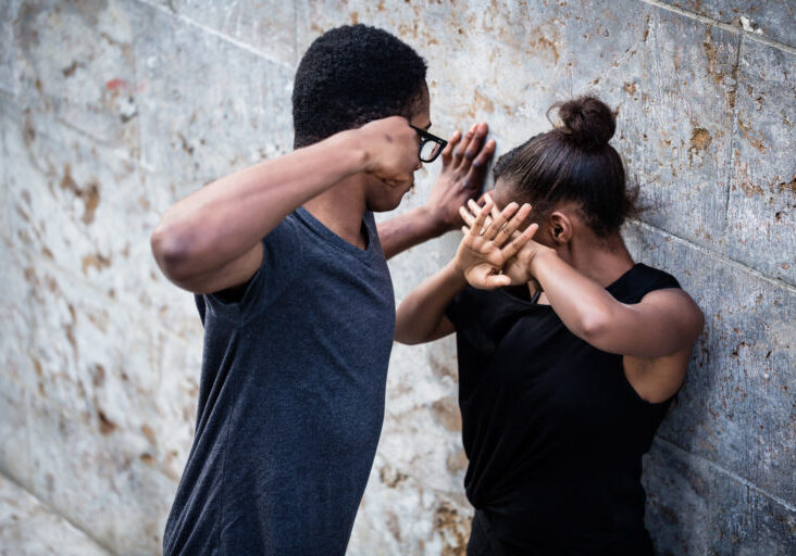 A man and woman are practicing self defense.