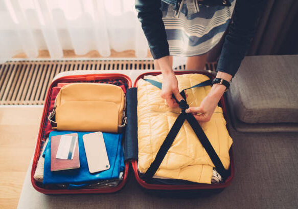 A person is packing their suitcase for vacation.