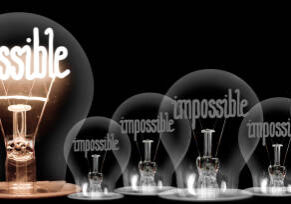 A light bulb with the word " impossible " in it.